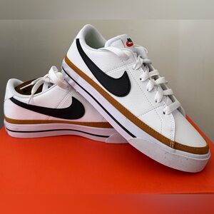 Nike White Low-Top Sneakers with Black Swoosh and Gold-Brown Stripe